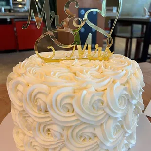 a wedding cake with the word mr and mrs on top