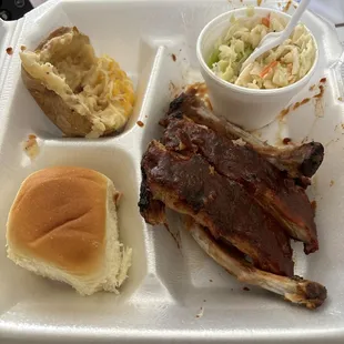 1-4 rack ribs with mild sauce, twice baked potato, Slaw and dinner roll.