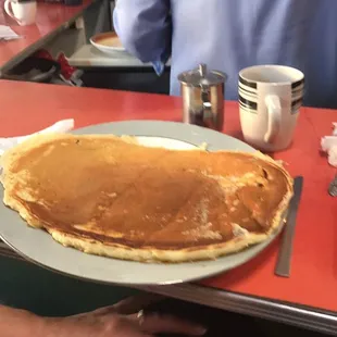 Medium pancake on a platter.