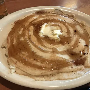 a plate of pancakes with butter and syrup
