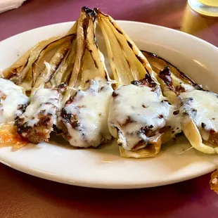 Appetizer of Stuffed Hot peppers with Italian sausage and provolone cheese.