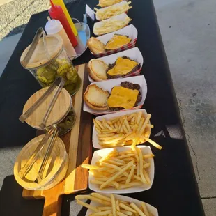 a long table with fries and pickles