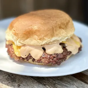 a close up of a burger on a plate