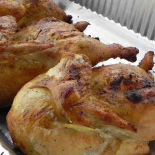three whole chickens in a foil pan