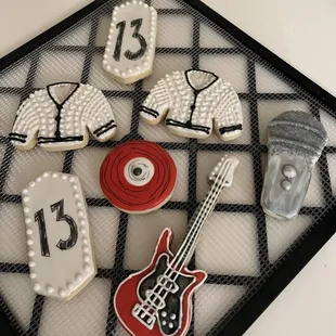 a guitar, shirt, and hat