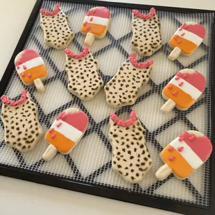 a tray of decorated ice cream pops