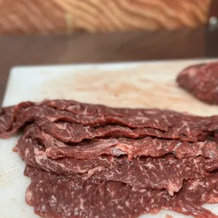 a close up of meat on a cutting board