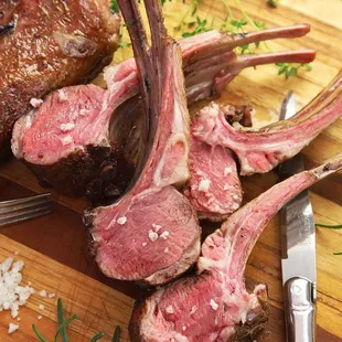 a rack of lamb chopping on a cutting board