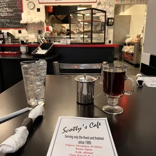 a menu and a glass of water