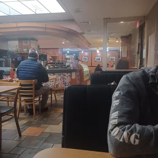 a man sitting at a table with a donut in front of him