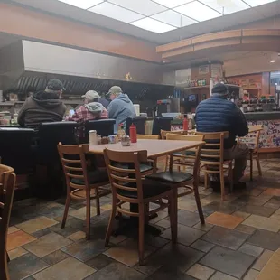 people sitting at tables in a restaurant