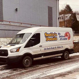a van parked on a snowy street