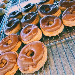 chocolate frosted donuts on a cooling rack