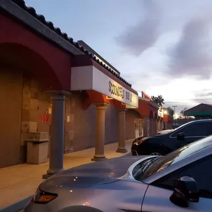 cars parked in front of a restaurant