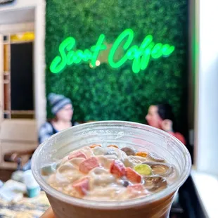 a hand holding a cup of coffee