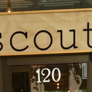 a storefront with a bird on the sign