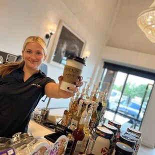 a woman holding a cup of coffee