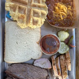 Explorers plate with tri tip, chicken, cornbread waffle, and beans