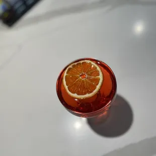an orange slice in a glass