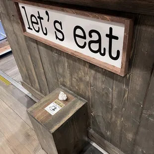 a sign that says let's eat
