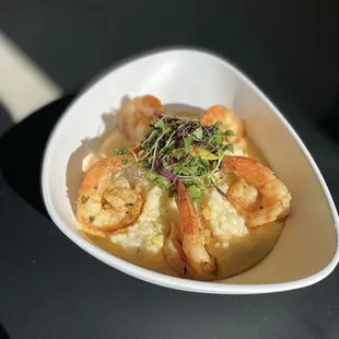 shrimp and grits in a white bowl