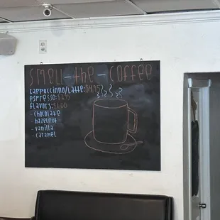 a chalkboard on the wall of a coffee shop