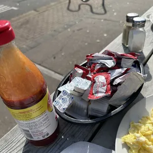 a plate of eggs and a bottle of ketchup