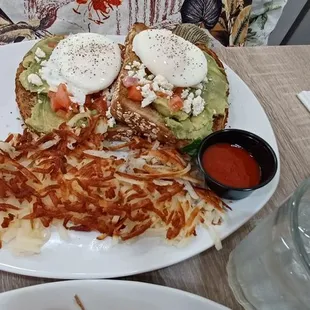 Poached eggs on avocado toast, hashbrowns