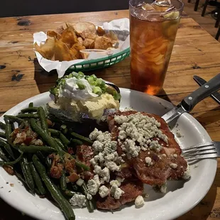 Had this just the other night. 2 bacon wrapped pork chops with blue cheese crumbles, green beans and baked potato.