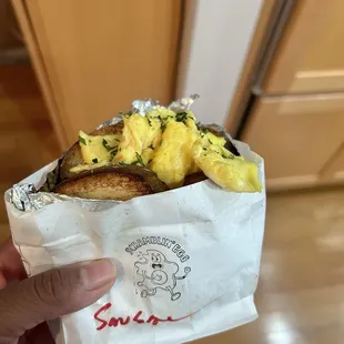  hand holding a sandwich