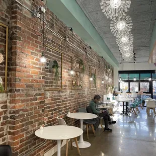 a brick wall and tables in a restaurant