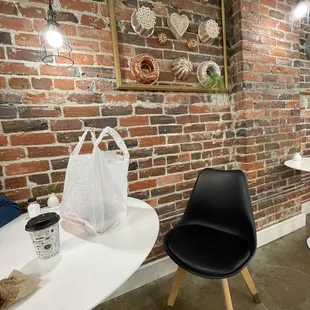 a brick wall and two chairs