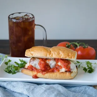 a sub sandwich with tomato sauce