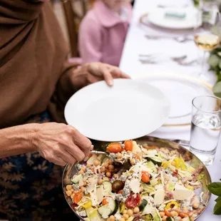 a woman serving a plate of food