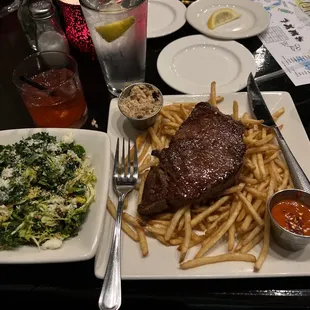 Sirloin steak and fries with kale and Brussels salad