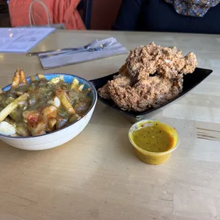 Cheese curd gravy fries, excellent crispy and juicy fried chicken tenders with house-made honey mustard sauce.
