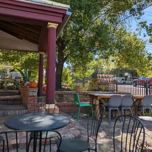 a patio with tables and chairs