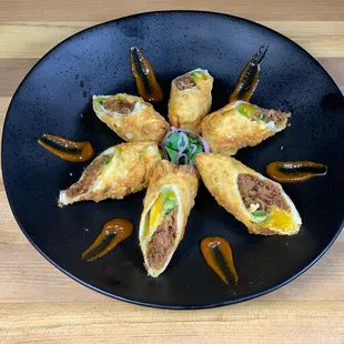 a plate of fried food on a wooden table