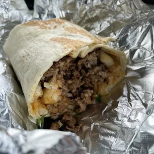 a burrito wrapped in aluminum foil
