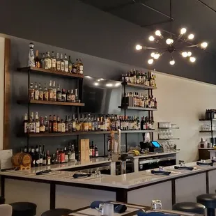 a view of a bar with a lot of bottles on the shelves