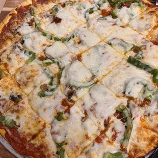 Large pizza with mushrooms, green peppers, pepperoni.