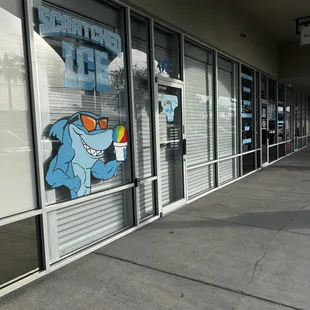 an ice cream shop with a shark on the window