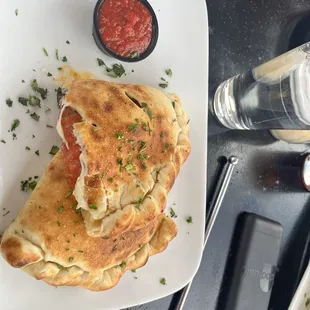 Calzone with pepperoni, olives, and extra mozzarella