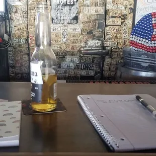a notepad and a bottle of beer
