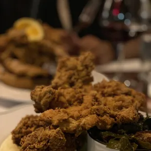Fried chicken dinner with mashed potatoes, gravy and collard greens