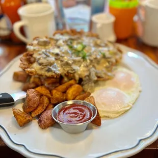 Chicken fried steak with mushroom Gravy and potatoes.