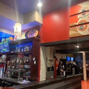 a restaurant with a bar and a television