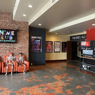 a brick wall and chairs in a lobby