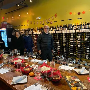 a group of people standing around a table