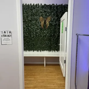 One of the two large handicap accessible dressing rooms, both have benches, large mirrors, clothing hooks.